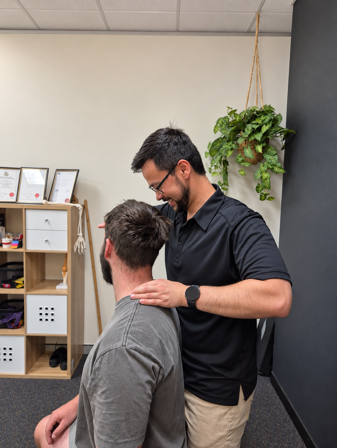 Tehan assessing a patient's neck at Momentum Health & Function, Albury